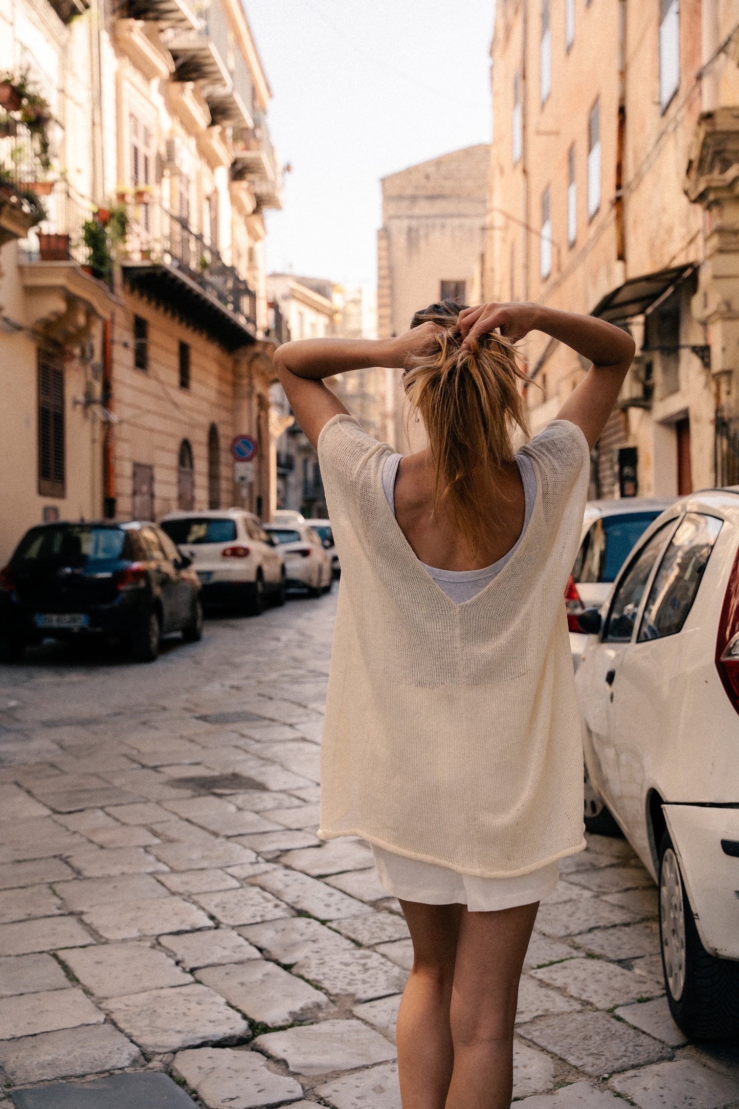 Oversized top with one straight side and one V-shaped side